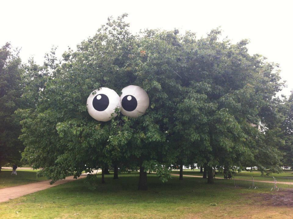 Beach balls painted to look like eyes put in a tree. Glow in the dark paint for