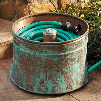Clever…. A washing machine, wash tub… good use for water hose storage.