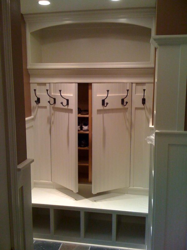 Hidden shoe rack storage behind coat rack. Great idea for mudroom! I love this!