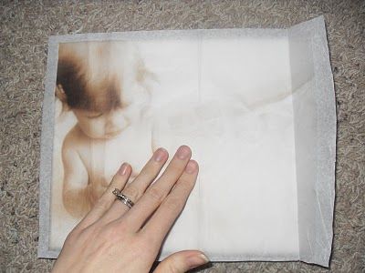 How to print your photos onto tissue paper then modge podge onto canvas.