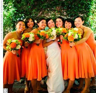 Pops of ivory and green look smashing when paired against orange bridesmaid dres