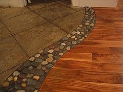 River rock between wood and tile floors. LOVE THIS!