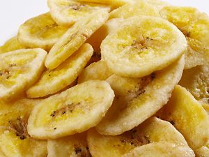 Slice banana into thin chips, dip in lemon juice, and spread on a cookie sheet.