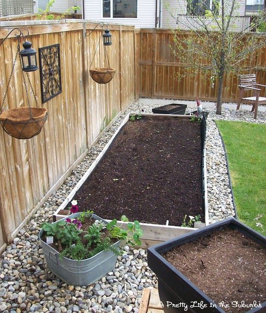 Stones around raised garden beds. Love this idea for a vegetable garden.