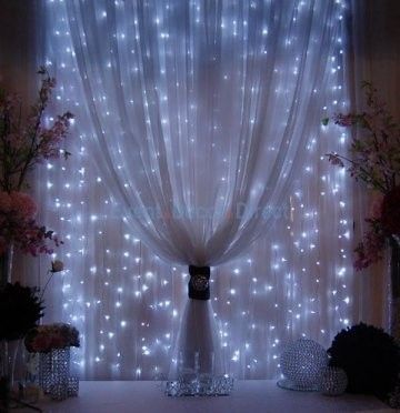 Strings of mini-lights attached to a rod behind sheer fabric. Beautiful!