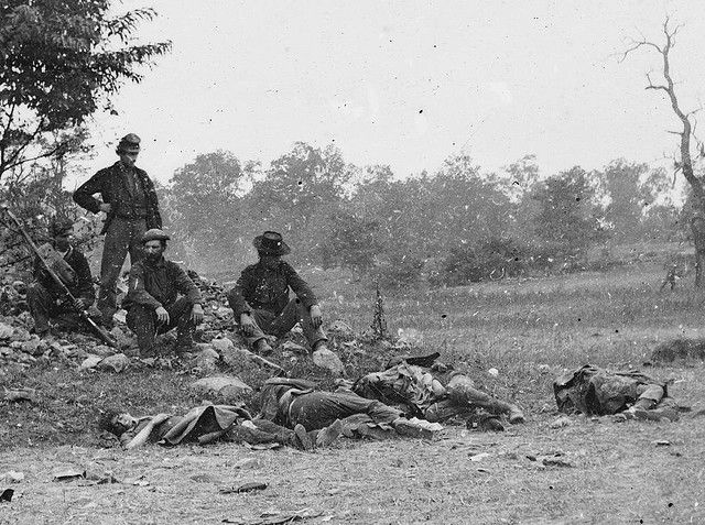 Union soldiers overlooking Confederate dead at Antietam.