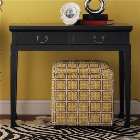 With its lightly distressed black satin finish, this console is perfectly sized