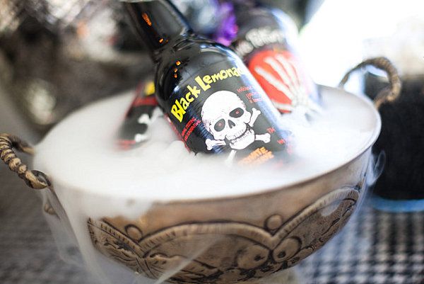 A Halloween drink display with dry ice -   40 Spooky Halloween Decorating Ideas for Your Stylish Home