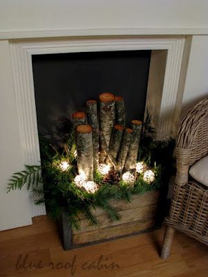 old crate filled with logs, greens, pinecones, and lights…This would look grea