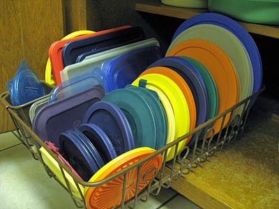 use a dish rack inside of a cupboard to organize/store your tupperware lids