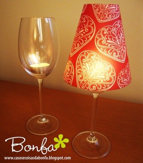 Cheap wine glass + tea light candle + paper cup with bottom cut out. So cute and