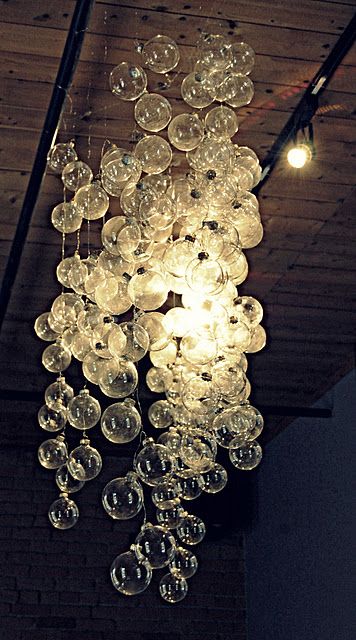 DIY "bubble" chandelier made from clear Christmas ornaments on string.