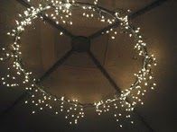 Great idea – 1 hula hoop (spray painted) + 2 strings of icicle lights and a bit