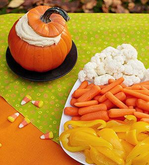 Healthy Halloween snack: Arrange cauliflower, carrots, and yellow peppers in the
