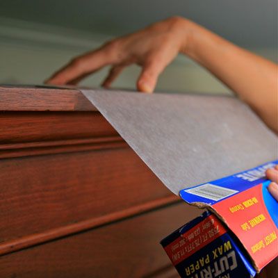 Place a layer of wax paper on top of upper kitchen cabinets where dust and greas