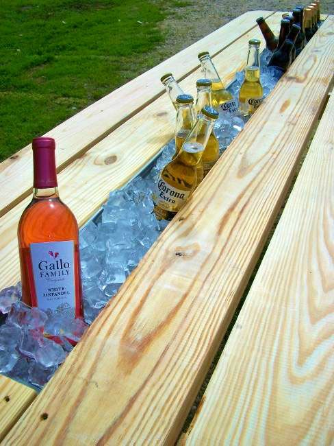 Replace the middle board of picnic table with rain gutter for drink cooler. Frea