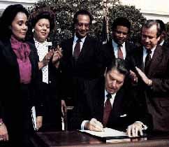 Ronald Reagan Signing the Bill to make MLK day official.