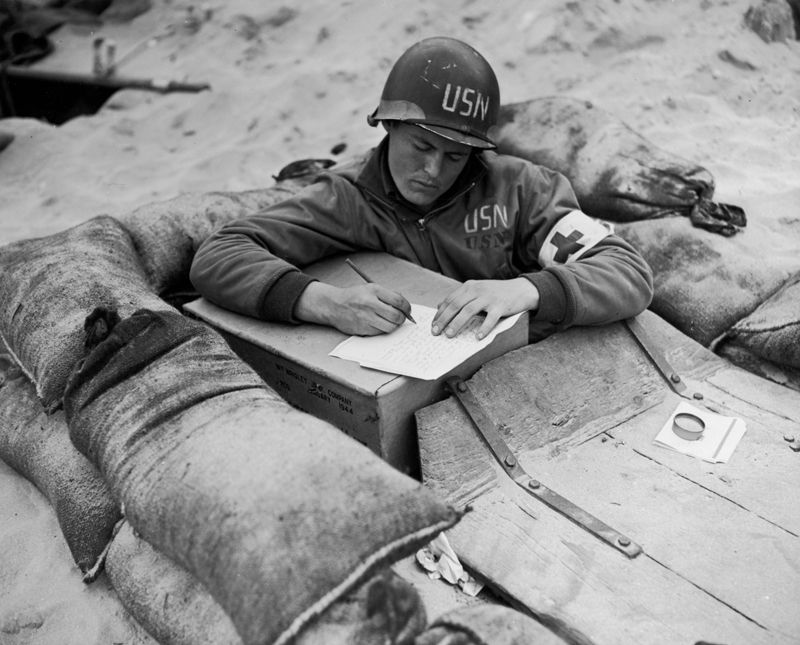 US Navy corpsman writing a letter.  (Morris Engel)