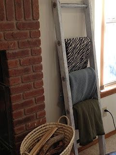 Use an antique ladder to hold extra blankets to cozy up with, so need one!