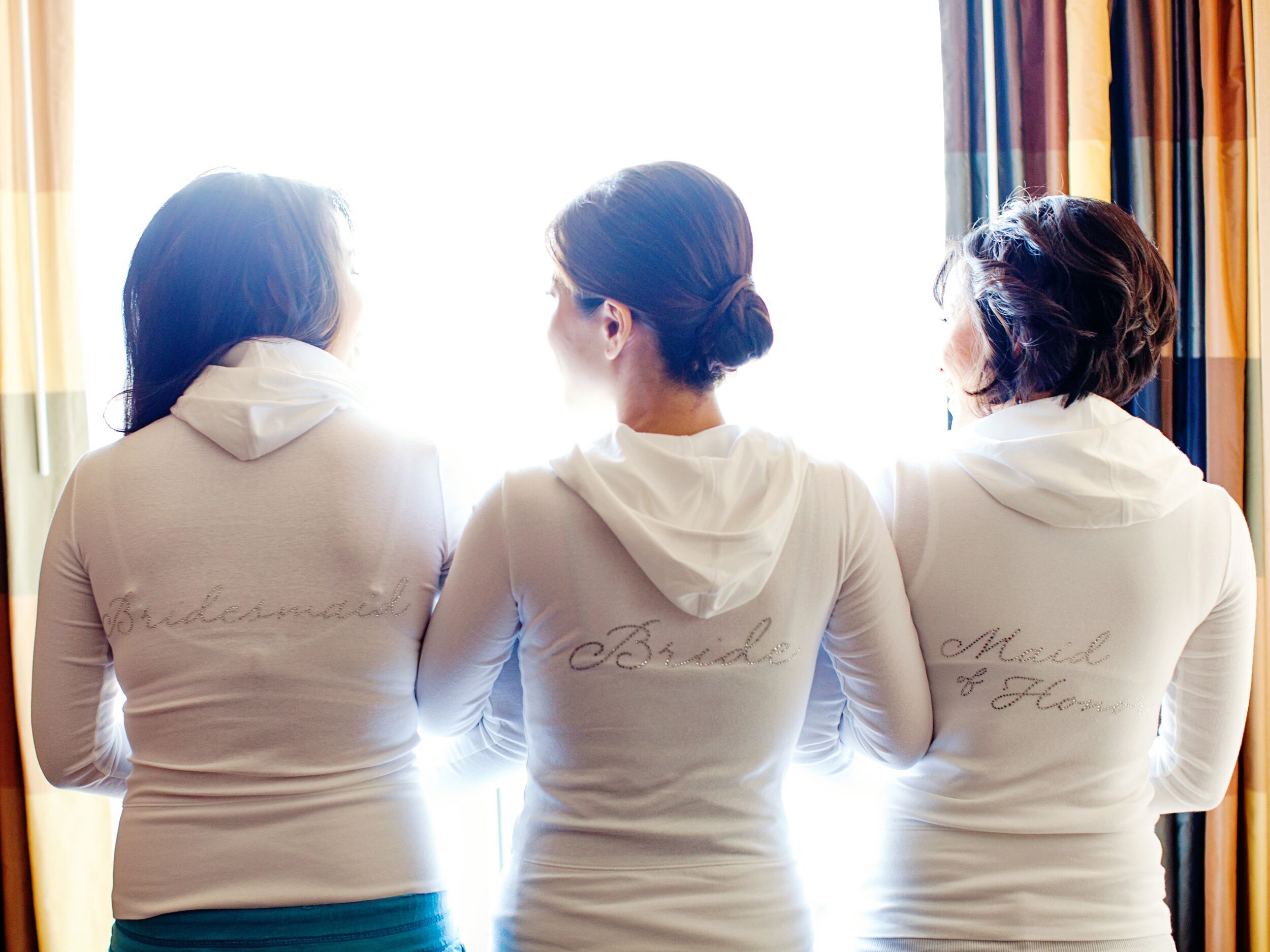 Bride and bridesmaids in matching white hoodies -   Great Personalized Bridesmaid Gifts