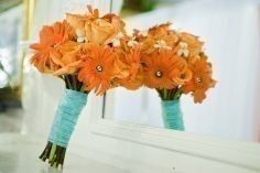 orange bouquet tied with teal