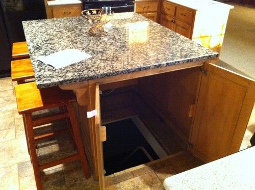 the door to an underground storm shelter or panic room in the kitchen island!