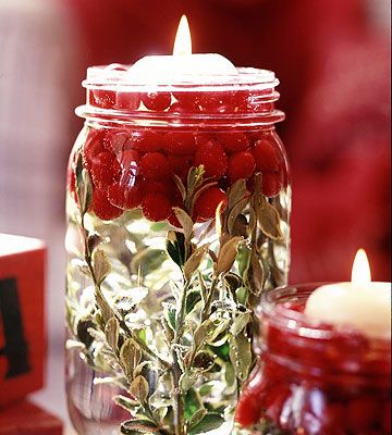 {way cute table decoration for Christmas dinner} mason jar, green leaves, cranbe