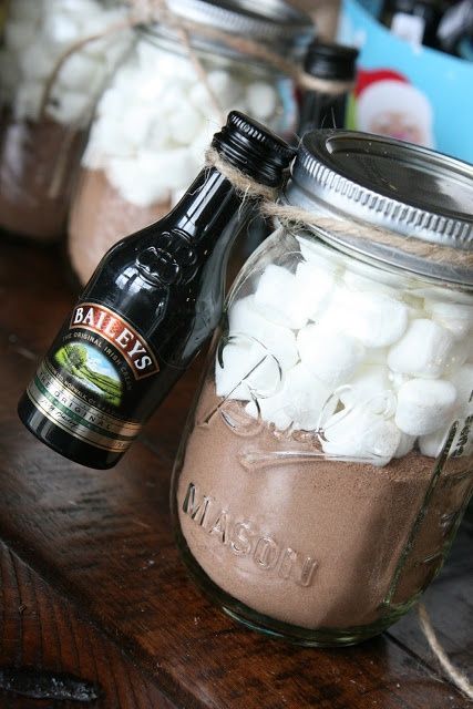 A mason jar of hot chocolate, a bottle of Bailey's, a few candy canes, a cof