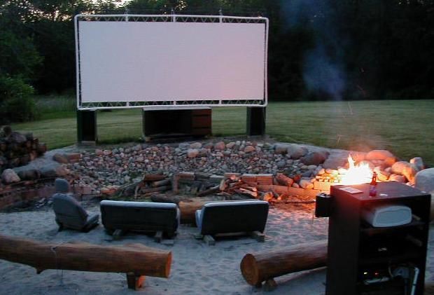 An outdoor movie screen, made with PVC pipes, tethers, and a white tarp. How awe