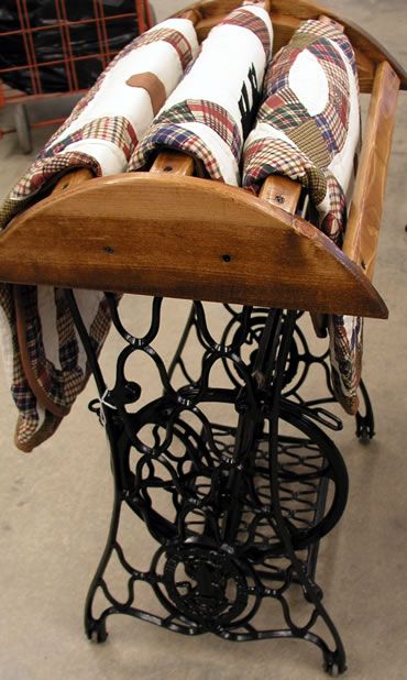 Antique sewing machine base turned quilt rack
