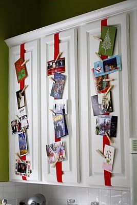 Attach ribbon to kitchen cabinets. Use clothespins to hang cards.