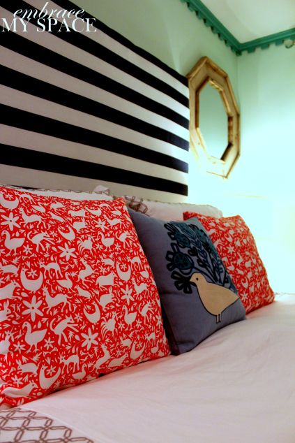 Bold stripes and otomi-inspired fabrics are stunning in this DIY headboard desig