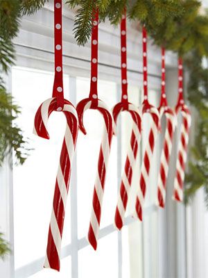 Candy canes hooked onto polka-dot ribbon livens up a window. How cute is this?