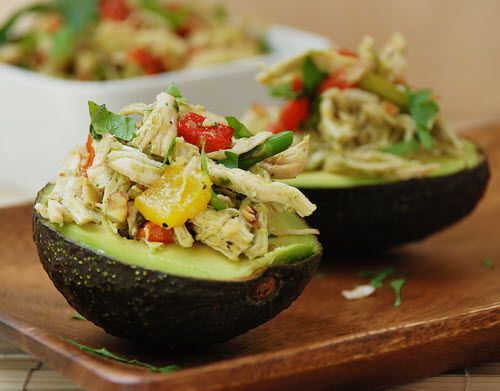 Chicken salad with roasted bell peppers in avocado cups.