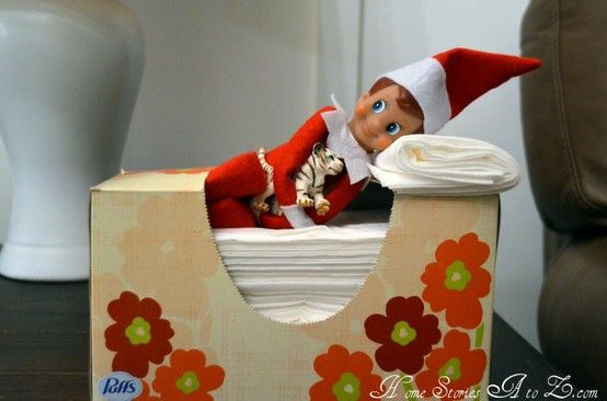 Elf on A Shelf napping in the kleenex box/bed.