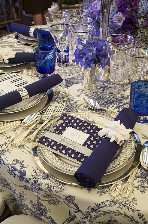 Navy blue toile tablecloths are accented with navy blue napkins and one of two m