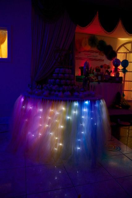 Rainbow lighted cupcake table at a Sweet 16 Party #sweet16 #party