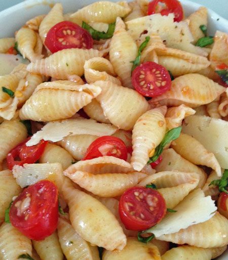 Seashell pasta salad with basil, tomatoes, mozzerella, and garlic. Super simple