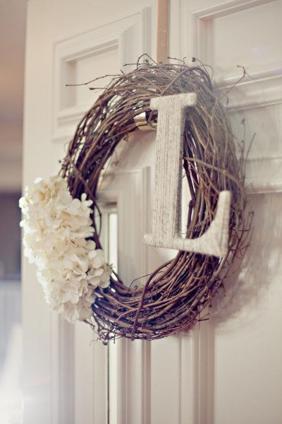 Style Me Pretty – grapevine wreath with soft white flowers and a whitewashed ini