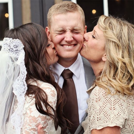 Sweet photo of the groom with his two favorite ladies — his bride and his