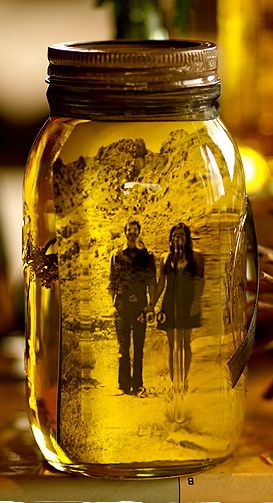 olive oil + picture + mason jar = cool way to display couple’s pictures on the t