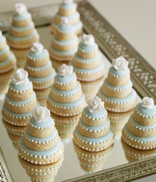 sugar cookies stacked into mini wedding cakes. perfect for bridal shower!