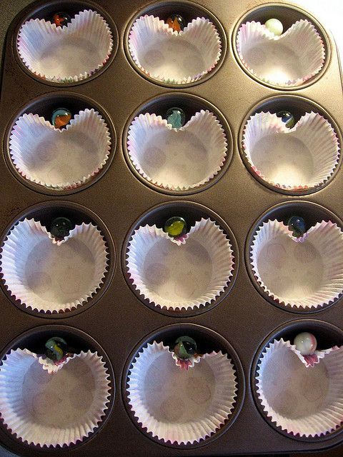 A simple way to get heart-shaped cupcakes: drop a marble between the paper cupca