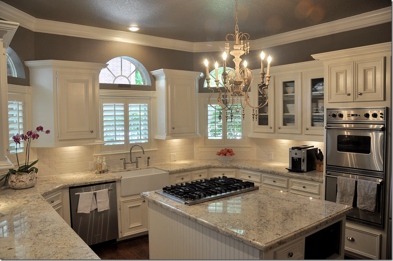Dark wood floor, white & gray granite, white cabinets, cream backsplash &