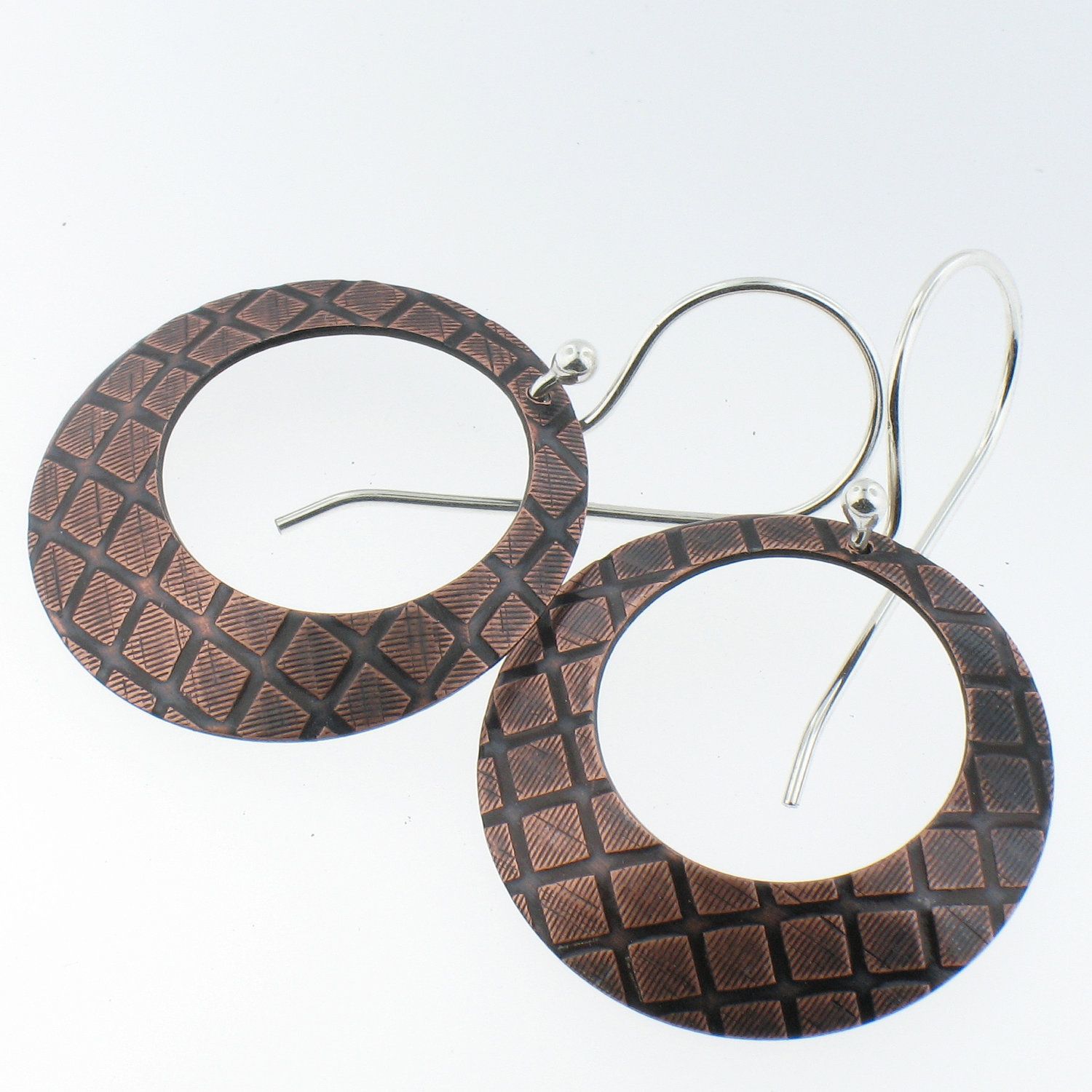 Handmade Copper Hoop Earrings with Sterling Sliver Ear Wires. $35.00, via Etsy.