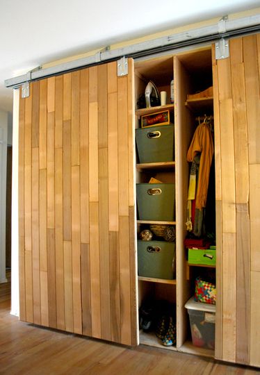 I love these reused closet doors. Repurposed wood flooring possibly. This gives