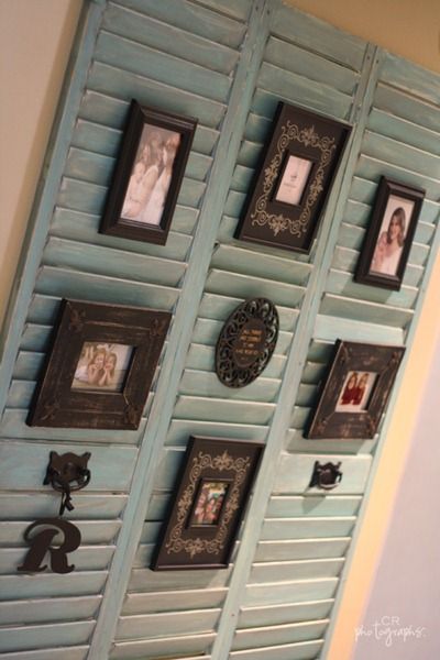 Old shutters to display pictures. Tuck the frame easel between the slats.