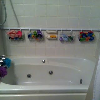 Shower Rod against back wall with wire hanging baskets for tub toy storage.