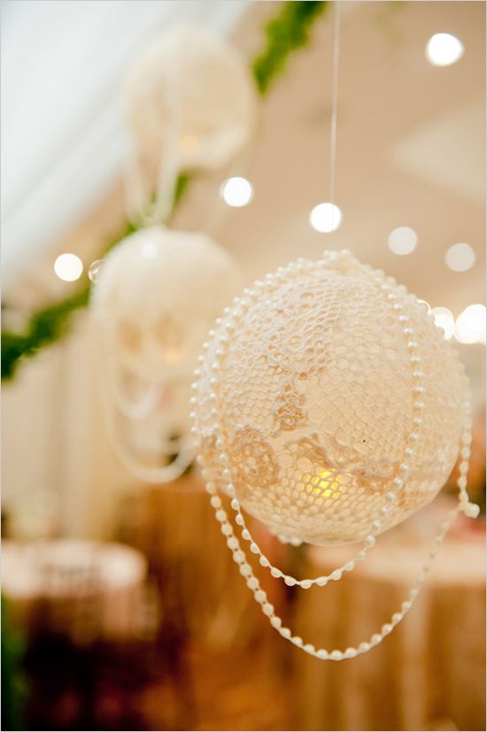 The lanterns are made by overlapping lace doilies on an inflated balloon and bru