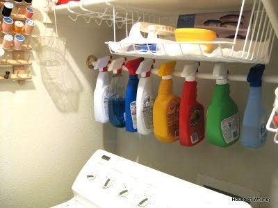 Use closet rod to organize spray bottles